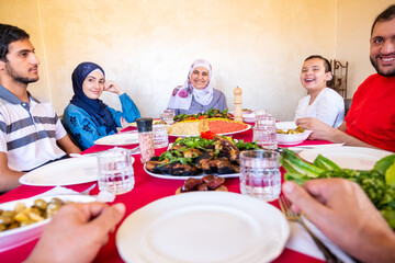 Happy arabic muslim family eating together in a family meeting 