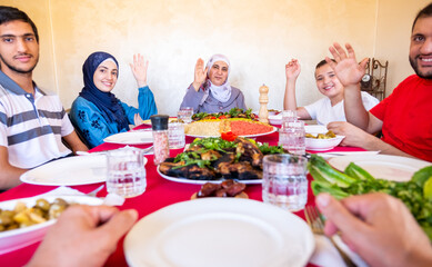 Happy arabic muslim family eating together in a family meeting 