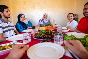 Happy arabic muslim family eating together in a family meeting