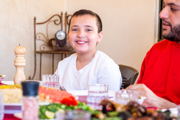 Happy arabic muslim family eating together in a family meeting 