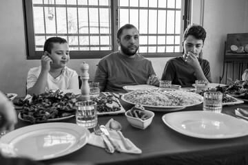 Happy arabic muslim family eating together in a family meeting 