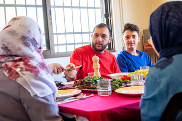 Arabic muslim family eating together in a meeting for iftar in ramadan