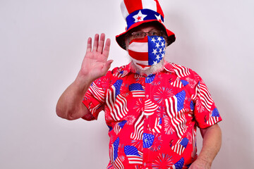 Man with funny uncle sam hat and patriotic shirt is waving with one hand..Patriotic man with a face...