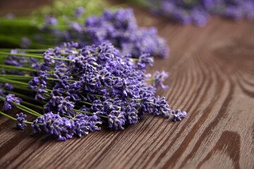 Fototapeta premium Romantic lavender flowers bouquet on wooden background