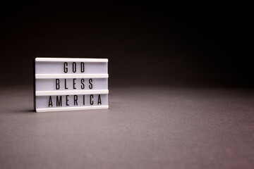 God Bless America inspirational and patriotic message board, shot in studio with copy space.