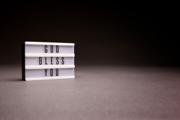 God Bless You inspirational message board with copy space, shot in studio.