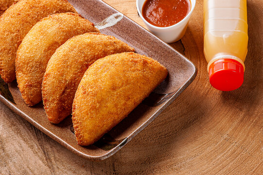 Brazilian appetizer deep fried beef croquette with pepper sauce and orange juice - Risolis