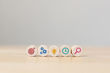 Conceptual of business strategy and action plan. Wooden sphere with icon aim, cog, lamp, time and...