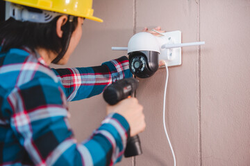 CCTV installation with young Asian technicians. Installation such as Wifi ip camera Concept:...