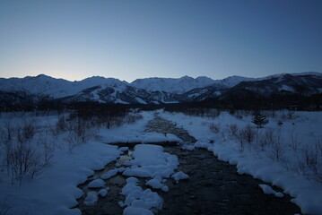 Morning landscape of snowed mountains and river in Japan, Hakuba