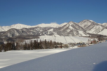 Fototapeta na wymiar Daytime shot of snowed mountains in northern alps of Japan, Hakuba