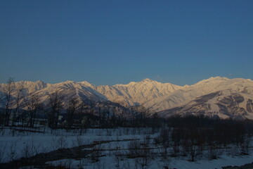 Fototapeta na wymiar Morning landscape of snowed mountains in northern alps of Japan, Hakuba