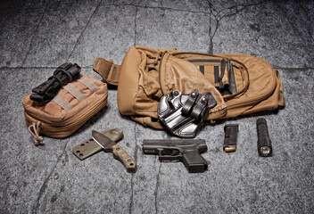 Everyday carry items, also known as EDC, displayed on a concrete floor.