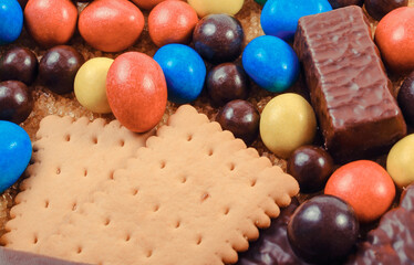 Natural brown cane sugar and candies with cookies. Unhealthy food and too many sweets