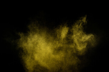 Yellow powder explosion on black background. Colored powder cloud. Colorful dust explode. Paint  Holi.