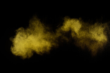 Yellow powder explosion on black background. Colored powder cloud. Colorful dust explode. Paint  Holi.