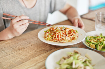young man eating spaghetti
