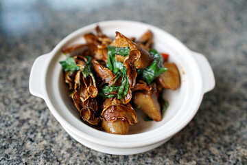 Homemade Abalone mushrooms with spicy sauce in clay pot.
