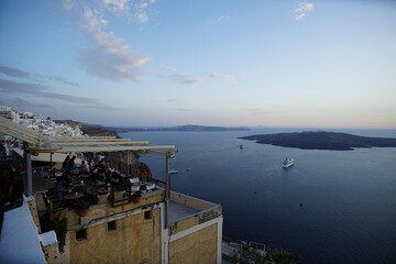 The sunset into the sea, seeing from street of Thira, Greece, Europe