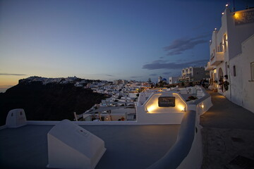 beautiful night street, blue sky and white buildings in santorini island, Greece, Europe
