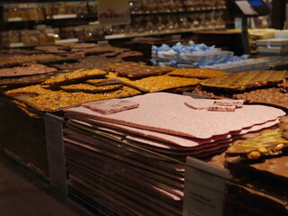Close-up photo of brown chocolate plates on a shelf for sale in a souvenir shop around a subway station in Switzerland.