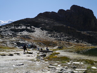 Tourists riding a bicycle on an adventure tour of the beautiful nature hiking trails of Matterhorn mountains, a nature attraction in Switzerland, August 15, 2015.