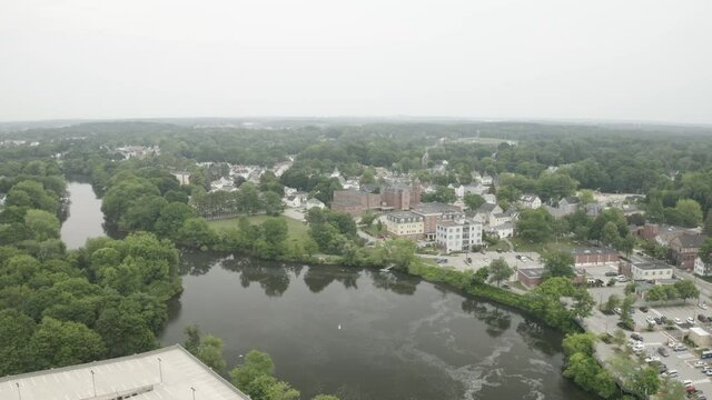 Aerial Fly Over Drone Footage over a lake in Downtown Westbrook in Maine, Cumberland County, USA