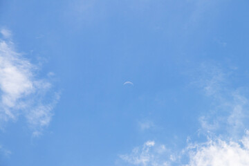 Crescent moon on blue sky. Look like a smile on a good day.
