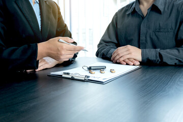 The car dealer advises the customer about insurance details and car rental information Ready...