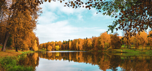 Late autumn nature landscape.Beautiful scene with forest lake and reflection on water surface.Trees with orange fall foliage.Cloudy autumn rainy morning.Calm weather.October scene.
