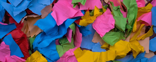 torn and crumpled color papers on a table