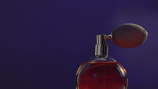 Vintage perfume bottle and shining light flares on dark background, glamorous fragrance scent as luxury perfumery product for cosmetic and beauty brand, stock footage