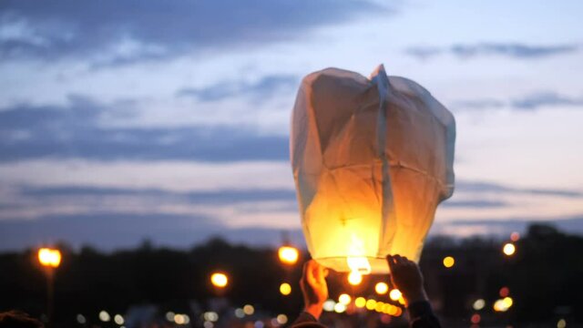 People on the bridge releasing a traditional flying lanterns at the promotion festival
