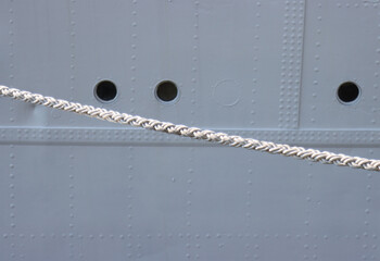 Ship hull and mooring lines.