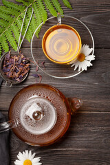 Obraz na płótnie Canvas Herbal tea in teapot and cup