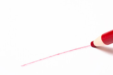 Red pencil with line over white background
