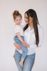 Portrait of Little girl with mom in studio. White background