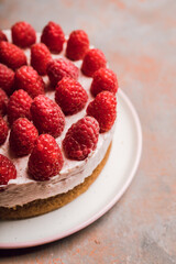 Fresh cheesecake with raspberries on the rustic background. Selective focus. Shallow depth of field. 