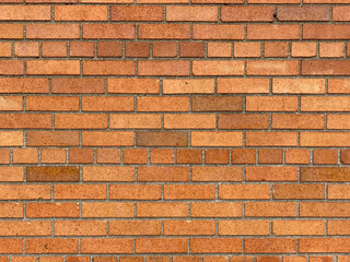 A brick wall with bright yellow tiles