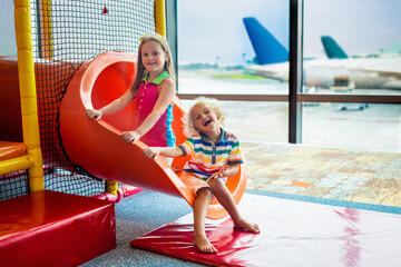 Fototapeta na wymiar Kids travel and fly. Child at airplane in airport