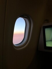 Photo of a sunset taken onboard the business class of commercial flight.