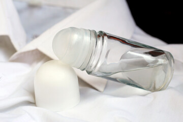 Fototapeta na wymiar deodorant with cup isolated on a white textile