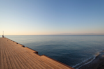 Obraz na płótnie Canvas Sea Pier in the early morning (oblique view to horizon)