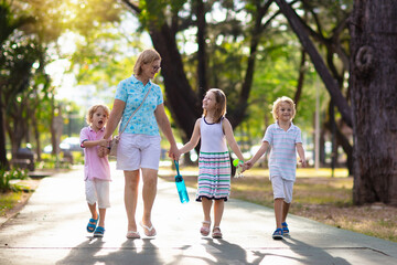 Mother and kids in sunny summer park