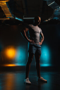 Young Sportsman Standing Against Orange Teal Background