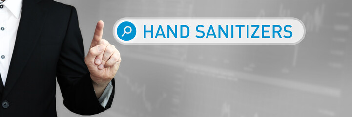 Hand sanitizers. Businessman (Man) in a suit pointing with his finger to a search box. The word is in focus. Blue Background. Business, Finance, Statistics, Analysis, Economy