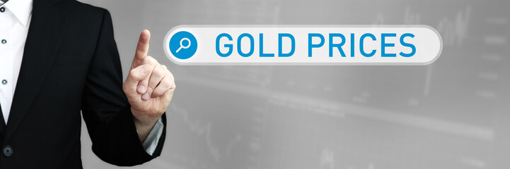 Gold prices. Businessman (Man) in a suit pointing with his finger to a search box. The word is in focus. Blue Background. Business, Finance, Statistics, Analysis, Economy