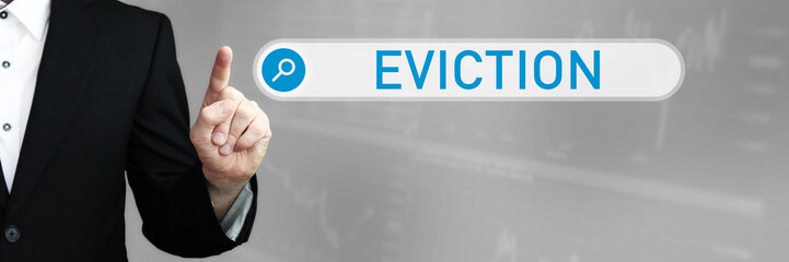 Eviction. Businessman (Man) in a suit pointing with his finger to a search box. The word is in...