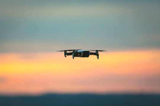Drone pilotage on the sky at sunset.