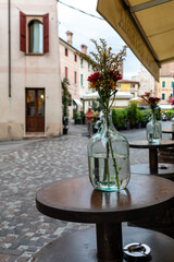  Typical street scene, with cafe tables, local and tourists in Bassano del Grappa, Veneto, Italy